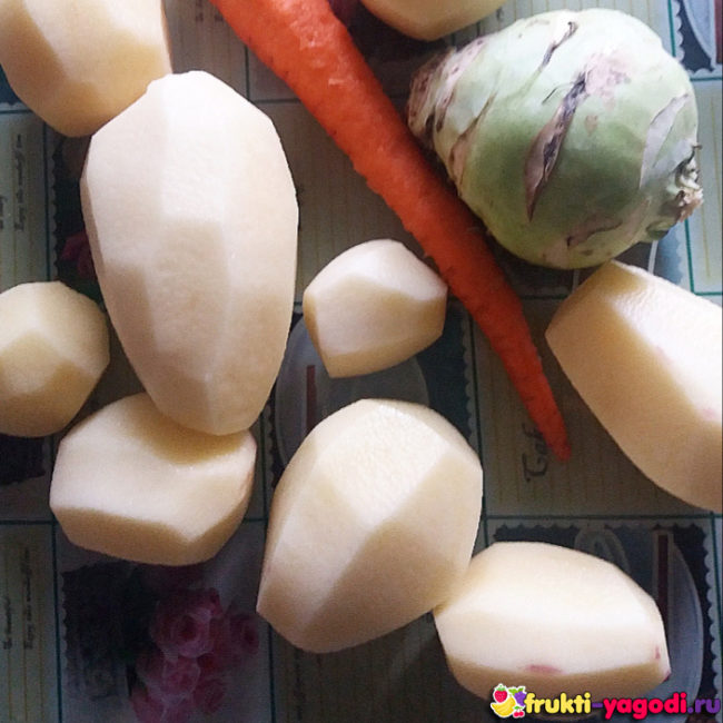Картошка, морковка и кольраби на столе для разделывания овощей